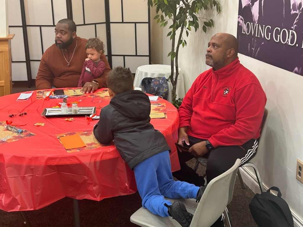 Families sharing a meal in the fellowship hall