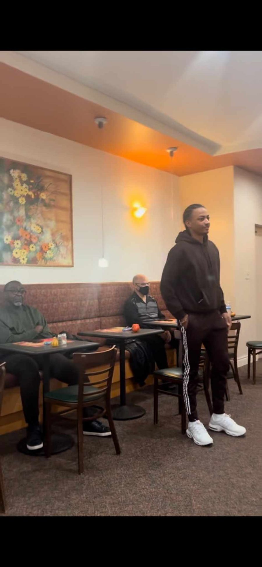 A young man speaking to the men's breakfast